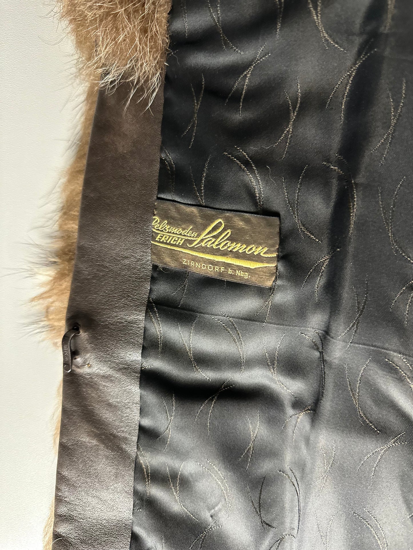 Tag inside brown vintage raccoon fur jacket