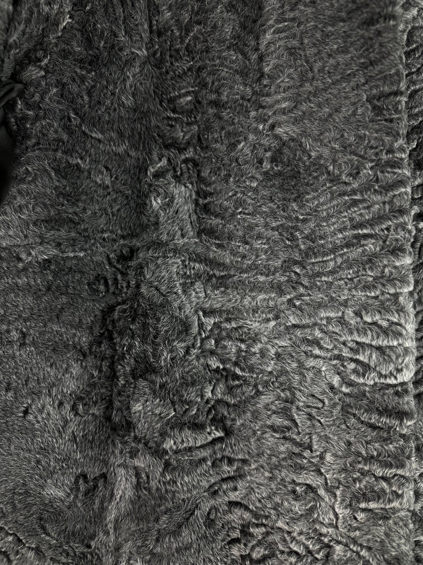 Close-up of grey vintage Persian lamb fur coat