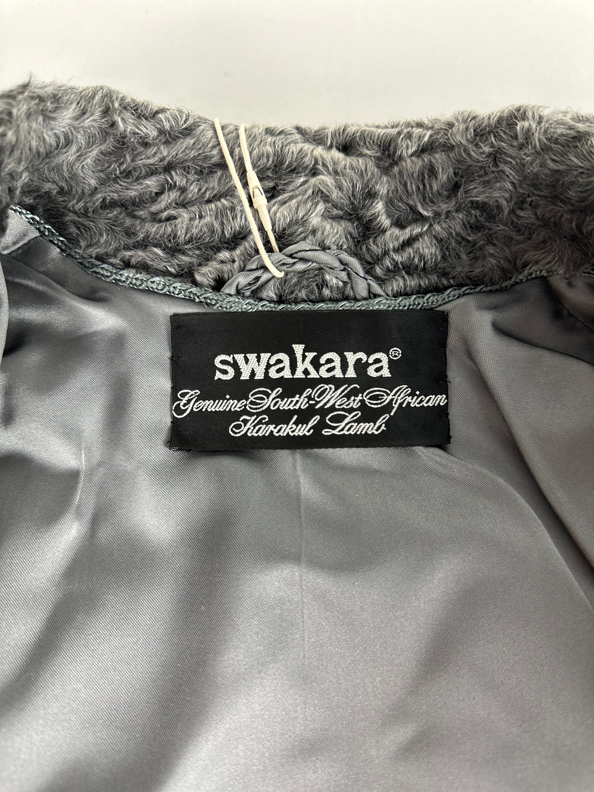 Tag inside grey vintage Persian lamb fur coat